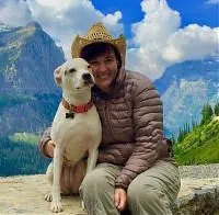 Dr. Beth Marszewski with a white dog in the mountains