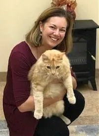 Dr. Jessica Bailes holding an orange cat